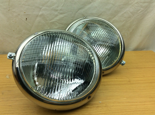 Complete headlight set ( as is ....new with 1 partially  cracked lens)